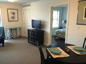 Washington apartment for rent - a living room and dining room with a tv and a table