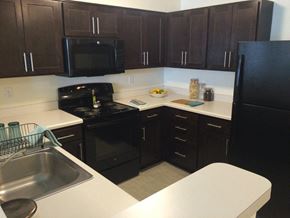 Washington apartment for rent - a kitchen with black appliances and white counter tops