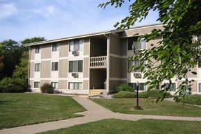 Holt apartment for rent - an apartment building with a sidewalk in the grass
