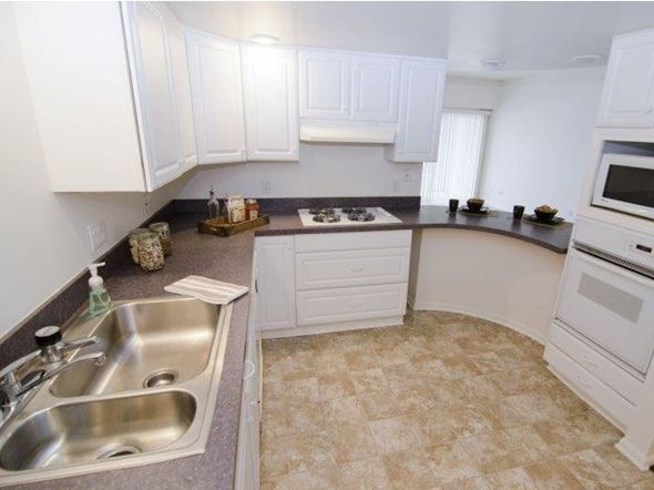 East Lansing apartment for rent - a kitchen with white cabinets and a sink
