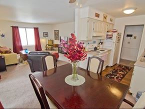 Lansing apartment for rent - a dining room table with a vase of flowers on it