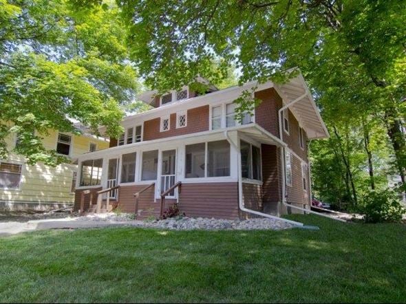 East Lansing triplex for rent - a brown and with a lawn and trees