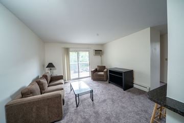 East Lansing apartment for rent - a living room with a couch and a coffee table