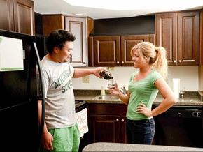 East Lansing apartment for rent - a man and a woman standing in a kitchen drinking wine