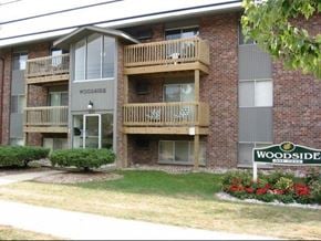 East Lansing apartment for rent - a brick apartment building with a sign in front