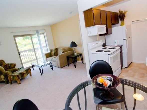 East Lansing apartment for rent - a living room with a kitchen and a table