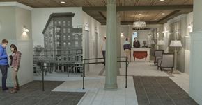 New Orleans apartment for rent - A man and woman stand in a hallway with a large black and white drawing of a building on the wall.