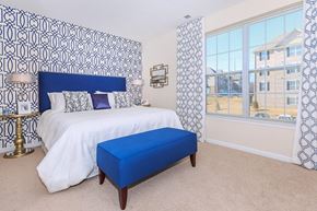 Middletown apartment for rent - a bedroom with a large bed and a blue ottoman