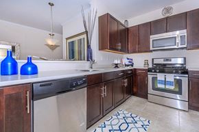 Middletown apartment for rent - a kitchen with stainless steel appliances and wooden cabinets