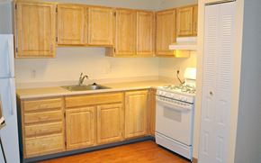Providence apartment for rent - A kitchen with wooden cabinets and a white stove.