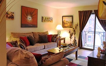 Providence apartment for rent - A living room with a couch, a coffee table, and a painting on the wall.
