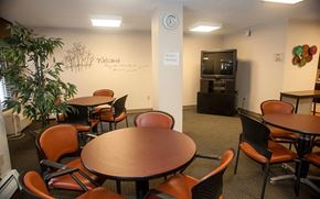 Framingham apartment for rent - a dining room with tables and chairs and a clock on the wall