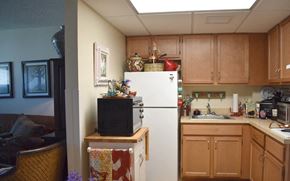 Melbourne apartment for rent - a kitchen with a white refrigerator and a microwave