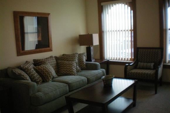 Spirit Lake apartment for rent - A living room with a couch, chair, and coffee table.