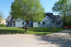Des Moines apartment for rent - a blue house with a tree and a fire hydrant
