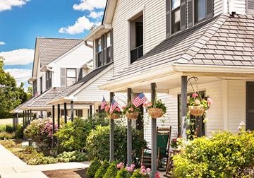 Bordentown apartment for rent - the front of a white house flags in hanging baskets
