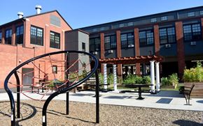 Hartford apartment for rent - a playground in front of a brick building