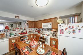 Kingstree apartment for rent - a kitchen with a wooden table and a white refrigerator