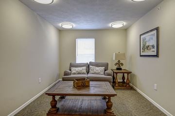 Wheeling apartment for rent - a living room with a couch and a table