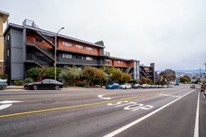 San Francisco apartment for rent - a city street with cars parked in front of a building