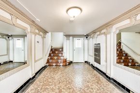 San Francisco apartment for rent - A hallway with a staircase and a tiled floor.