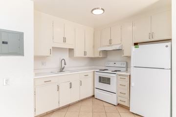 San Francisco apartment for rent - A kitchen with white appliances and cabinets.