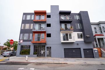 San Francisco apartment for rent - A grey building with a red and white stop sign in front of it.