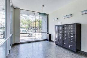 San Francisco apartment for rent - A room with a black filing cabinet and a glass door leading to a parking lot.