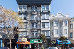 San Francisco apartment for rent - A street view of a city with buildings, cars, and trees.