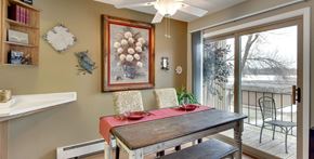 Robbinsdale triplex for rent - A dining room with a table set for two and a view of the outdoors.