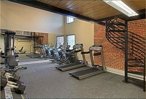 Petersburg apartment for rent - a gym with cardio equipment and a spiral staircase