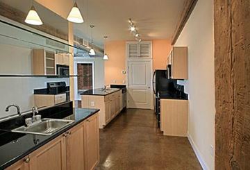 Petersburg apartment for rent - a large kitchen with black counter tops and wooden cabinets