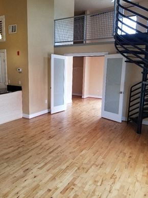 Petersburg apartment for rent - an empty living room with wood floors and a staircase
