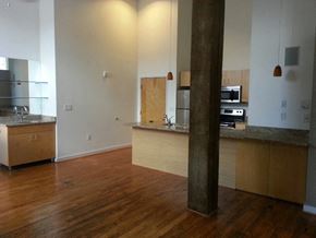 Petersburg apartment for rent - an empty kitchen and living room with a wood floor