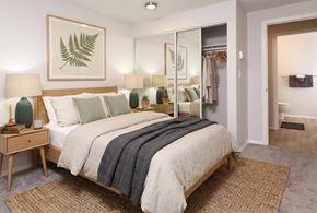 Seattle apartment for rent - A bedroom with a large bed and a mirror on the wall.