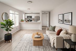 Seattle apartment for rent - A living room with a couch, coffee table, and a potted plant.