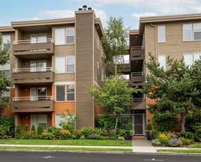 Seattle apartment for rent - A brown apartment building with a gate in front.