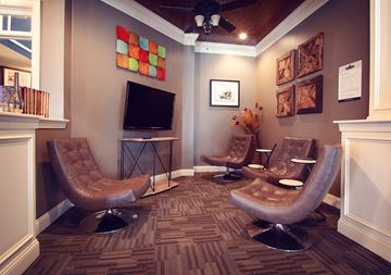 Greenville apartment for rent - a living room with three chairs and a television