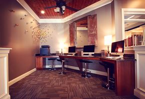 Greenville apartment for rent - a desk with two computers and a mirror in a room