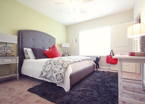 Greenville apartment for rent - a bedroom with a bed and a desk and a window