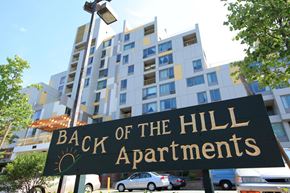Jamaica Plain apartment for rent - a sign for back of the hill apartments in front of a building