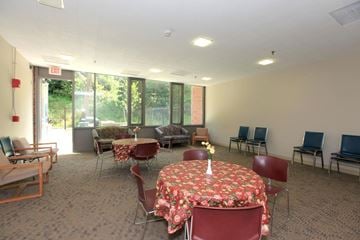 Jamaica Plain apartment for rent - a conference room with tables and chairs and a large window