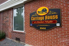 New Bedford apartment for rent - a sign for a carriage house on the side of a brick building