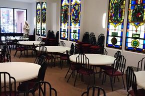 Boston apartment for rent - a dining room with white tables and chairs and stained glass windows