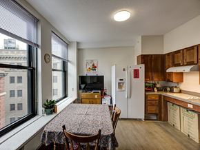 Boston apartment for rent - an open kitchen and dining room with a table and chairs