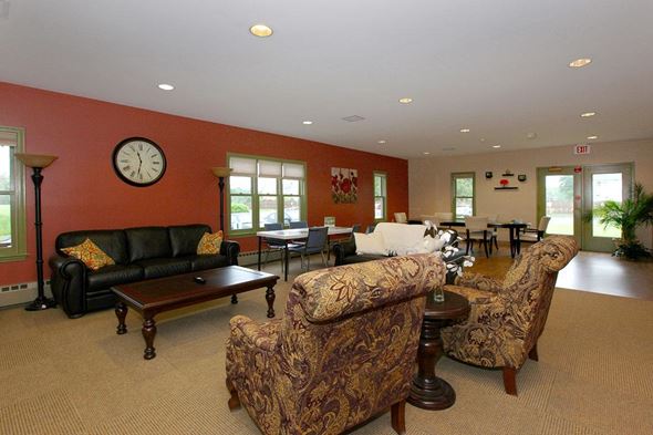 Easthampton apartment for rent - a living room with couches and chairs and a clock on the wall