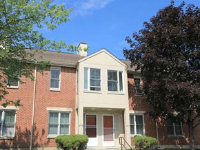 Lexington townhouse for rent - an apartment building with a red brick facade and a porch
