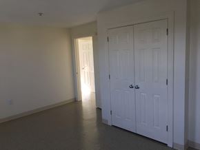 Somerville apartment for rent - a bedroom with two closets and a door to a hallway