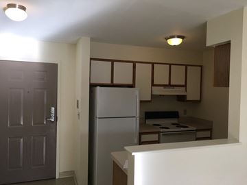 Somerville apartment for rent - a kitchen with a refrigerator and a stove and a door