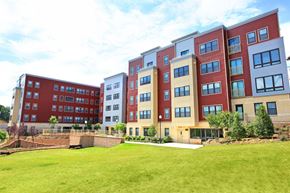 Washington apartment for rent - the exterior of an apartment building with a green lawn